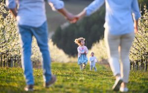 family with two small children on walk outdoors in Y54KTNX