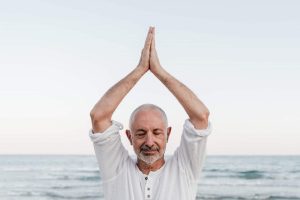 senior man doing yoga meditation outdoor at the be 2022 01 18 23 32 52 utc